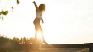 Person standing in morning sunlight to boost energy naturally without coffee through light exposure and movement.