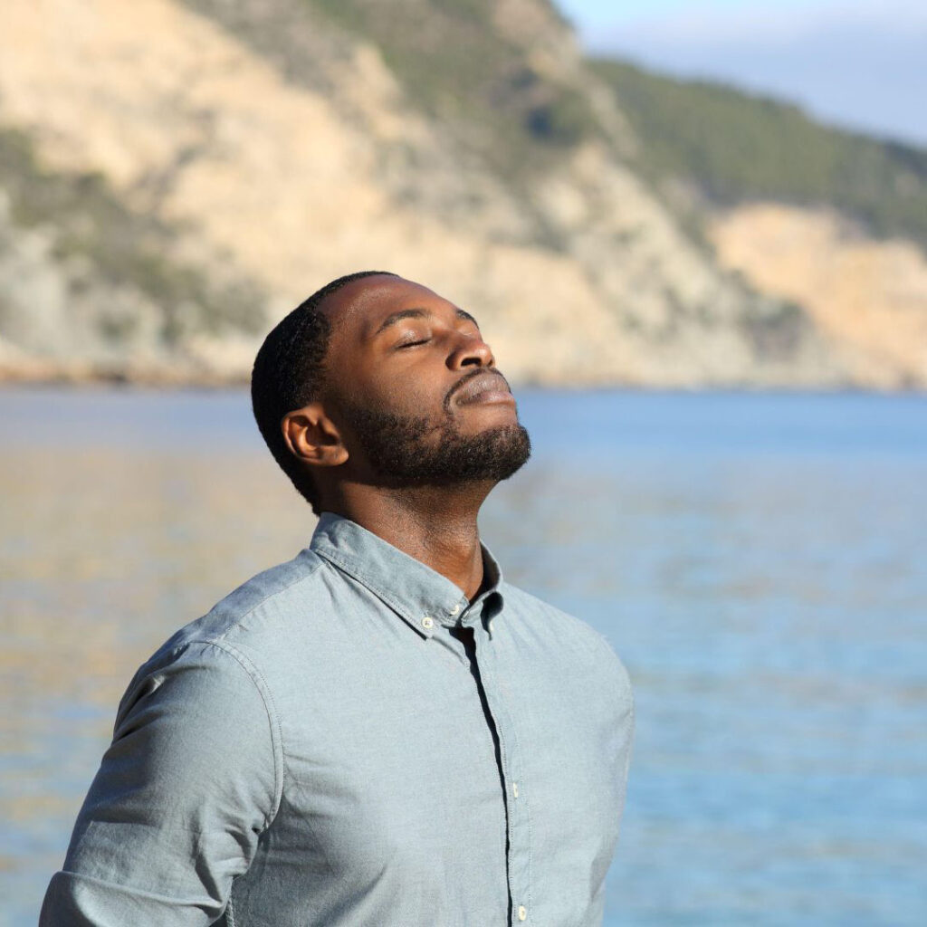 Person breathing deeply outdoors representing oxygen use and energy production